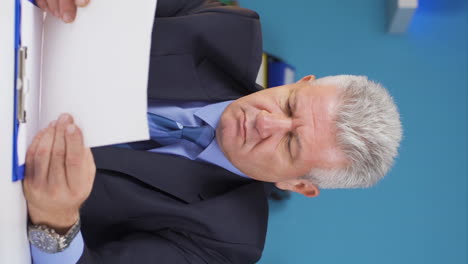 Vertical-video-of-Businessman-signing-paperwork-feeling-happy.